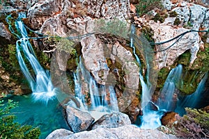 Majestic Big waterfall cascading down a rugged cliff in Kourtaliotiko Gorge, Foinikas, Crete, Greece