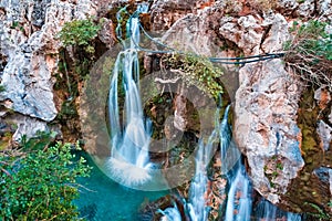 Majestic Big waterfall cascading down a rugged cliff in Kourtaliotiko Gorge, Foinikas, Crete, Greece