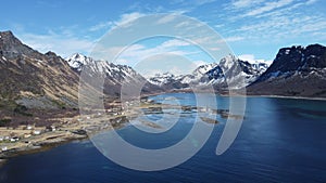 Majestic blue fjord surrounded by mighty mountains on the island of senja in the small fishing village of Grunnfarnes, northern No