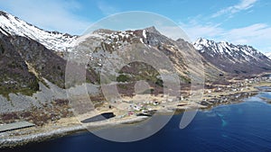 Majestic blue fjord surrounded by mighty mountains on the island of senja in the small fishing village of Grunnfarnes, northern No