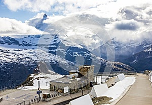 Majestic Dreamy View of snowy Gornergrat station and the iconic Matterhorn Peak shrouded with clouds, Zermatt, Switzerland, Europe