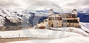 Majestic Dreamy View of snowy Gornergrat station and Matterhorn shrouded with clouds, Zermatt, Switzerland, Europe