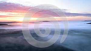 Majestic drone landscape image of sea of fog rolling across South Downs English countryside during Spring sunrise