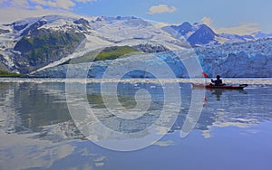 Majestic glacier and kayaker reflection in alaska