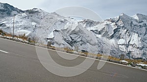 Majestic Grossglockner Mountain Road in Austria, snow covered sharp peaks of the alpine mountains. POV shot of most