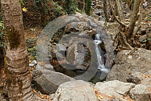 Majestic hidden waterfall in natural forest landscape. Beautiful river stream in the forest