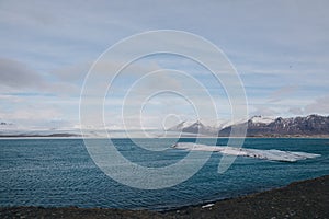 majestic icelandic landscape with snow-covered mountains and ice in harbour,