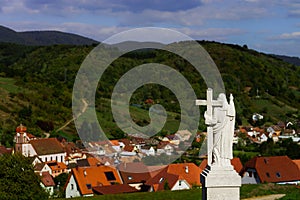 Majestic Jesus Christ sculpture over little french village