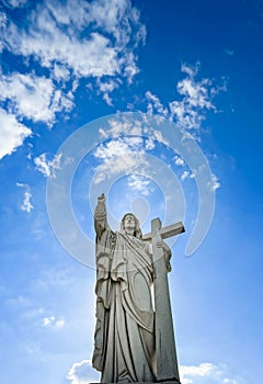 Majestic Jesus Christ sculpture over little french village