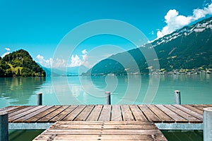 Majestic lake with clear turquoise water. Wooden pier. Brienz lake in the village of Iseltwald, Switzerland.