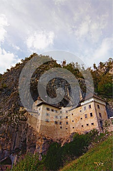 Majestic landscape of medieval Predjama castle Slovene. Predjamski grad. Castle at the cave mouth. Famous touristic place and