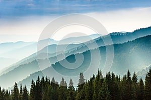 Majestic landscape of summer mountains. A view of the misty slopes of the mountains in the distance.