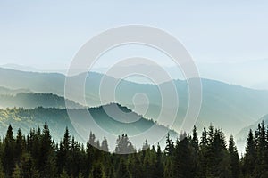 Majestic landscape of summer mountains. A view of the misty slopes of the mountains in the distance.