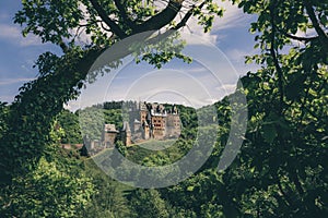 Majestic landscape view of the Eltz Castle set against a lush woodland, Germany