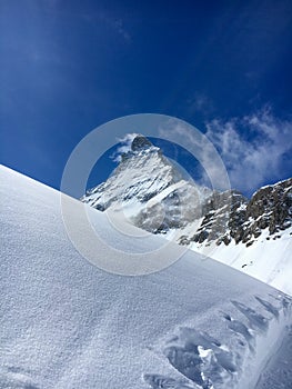 Majestic Matterhorn mountain in front of a blue sky
