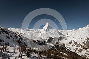 Majestic Matterhorn mountain in front of a blue sky