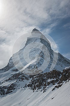 Majestic Matterhorn mountain in front of a partly cloudy sky