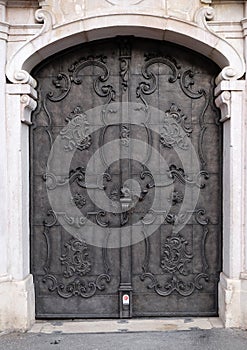 Majestic medieval door with ornate metal pattern and stone columns in Salzburg