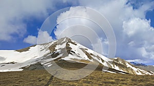 Majestic Mountain Peaks covered with Snow and soaring blue skies