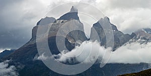 Majestic Mountain Peaks Emerge from Misty Clouds