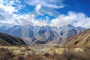 majestic mountain range in the daytime, with blue skies and puffy clouds