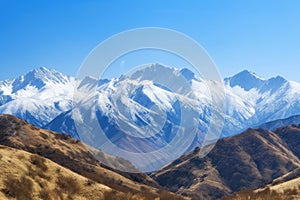 majestic mountain range, with snow-capped peaks and clear blue skies