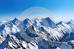 majestic mountain range, with snow-covered peaks and clear blue skies