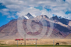 Majestic mountains and horse on meadows in Pamirs plateau