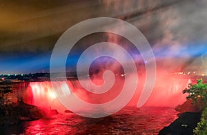 Majestic Niagara Falls at night, illuminated for a light show, view from canadian side