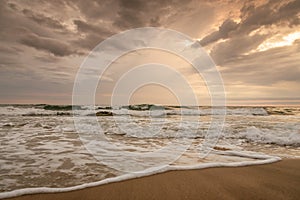 Majestic ocean sunset with a breaking wave