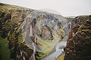 majestic rocky mountains with green vegetation and small river