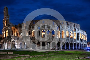 The majestic Rome Colosseum stands illuminated against the night sky in Italy