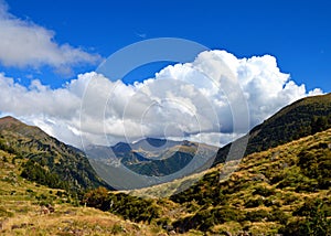 Majestic shot of a heavily clouded sky over a forested mountain range