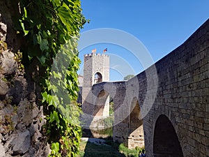 Majestic stone arched bridge in Besalu - famous medieval village Catalonia, Spain. Amazing atmospheric place for tourism near Me