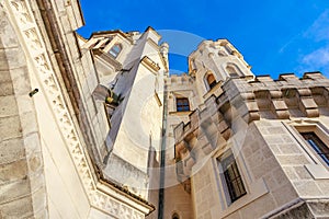 Majestic stone castle facade against clear blue sky