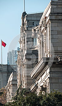 Majestic stone edifice with a flag gracefully waving on its facade. Wuhan, China