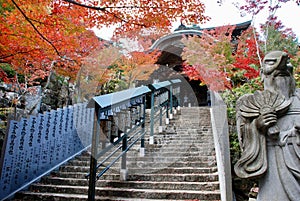 Majestic stone statue in front of the stone stairs of Daishoin Temple, Miyajima