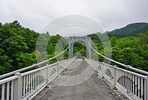 Majestic stony bridge for pedestrians spanning over the green valley in Nikko, Japan