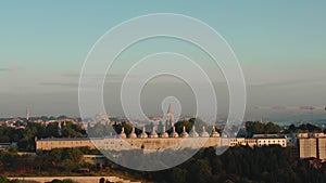 Majestic sunrise background view, drone rising over Hagia Sophia wall to reveal amazing Istanbul historic part scenery