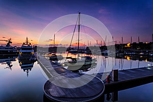 A majestic sunrise with boat resting near the dock as foregrou