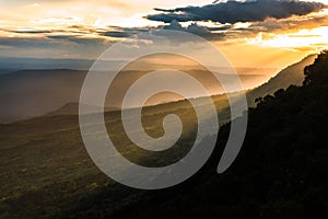 Majestic sunset in the mountains landscape with sunny beams. Dramatic scene