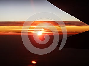 Majestic Sunset View from Airplane Wing at High Altitude