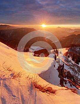 Majestic sunset in the winter mountains landscape. Dramatic sky