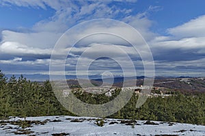 Majestic view of cloudy sky, winter mountain, snowy glade, residential district, conifer and deciduous forest from Plana mountain