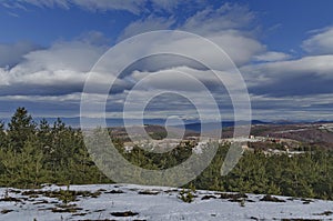 Majestic view of cloudy sky, winter mountain, snowy glade, residential district, conifer and deciduous forest from Plana mountain