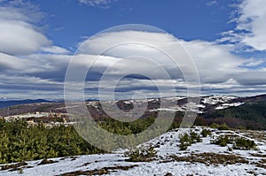 Majestic view of cloudy sky, winter mountain, snowy glade, residential district, conifer and deciduous forest from Plana mountain