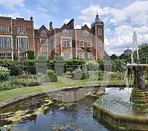 A majestic view of Hatfield House in Hertfordshire towering over manicured lawns and gardens