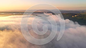 Majestic view over the beautiful ocean of clouds at sunrise. Cinematic aerial shot