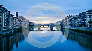 Majestic view of Ponte Vecchio and calm Arno river after thunderstorm in Florence Italy