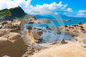 Majestic View of Potholes and Melted Rock Formations With Scattered Clouds in the Background in Yehliu Geopark, Taiwan